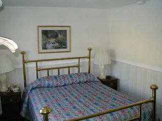 The Jacuzzi Suite with its brass queen bed