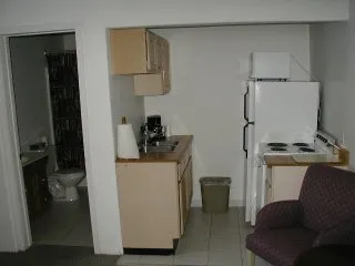 A clean, fully equipped kitchen in one of the rooms